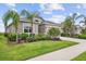Charming home exterior with well-maintained landscaping, palm trees, and a welcoming curb appeal at 12339 Glenridge Ln, Parrish, FL 34219