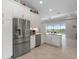 Bright kitchen featuring white cabinets, stainless steel appliances, and a view to the pool at 12339 Glenridge Ln, Parrish, FL 34219