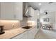 Modern kitchen with granite countertops, stainless steel appliances, and white cabinets. Adjacent breakfast nook at 12339 Glenridge Ln, Parrish, FL 34219