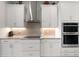 Modern kitchen features white cabinets, granite countertops, stainless steel appliances and tiled backsplash at 12339 Glenridge Ln, Parrish, FL 34219