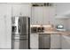 Modern kitchen featuring stainless steel appliances, white cabinets, and granite countertops for a sleek and functional design at 12339 Glenridge Ln, Parrish, FL 34219