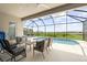Screened-in lanai with a pool, comfortable seating, and views of the backyard at 12339 Glenridge Ln, Parrish, FL 34219