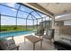 Screened lanai featuring an outdoor pool, and comfortable patio seating overlooking the yard at 12339 Glenridge Ln, Parrish, FL 34219
