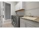 Functional laundry room featuring modern appliances and ample counter space with a sink at 12339 Glenridge Ln, Parrish, FL 34219