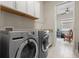 Well-equipped laundry room with modern washer and dryer and ample storage space at 12339 Glenridge Ln, Parrish, FL 34219