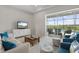 Bright living room featuring a large window view of the screened-in pool and backyard at 12339 Glenridge Ln, Parrish, FL 34219