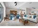 Bright and open living room featuring stylish furniture, ceiling fan, and seamless transition to the kitchen and dining area at 12339 Glenridge Ln, Parrish, FL 34219