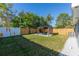 Spacious backyard with green lawn, wood fence, and pergola covered patio area at 1234 29Th St N, St Petersburg, FL 33713