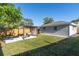 Spacious backyard with green lawn, wood fence, and pergola covered patio area at 1234 29Th St N, St Petersburg, FL 33713