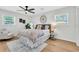 Cozy bedroom featuring natural light, ceiling fan, hardwood floors, and neutral decor at 1234 29Th St N, St Petersburg, FL 33713