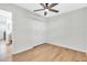 Bright bedroom featuring sleek ceiling fan, closet, and stylish light wood flooring at 1234 29Th St N, St Petersburg, FL 33713