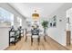 Dining room with modern light fixture, hardwood floors, and access to the kitchen at 1234 29Th St N, St Petersburg, FL 33713