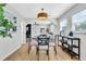 Cozy dining area featuring a modern light fixture and adjacent living area at 1234 29Th St N, St Petersburg, FL 33713