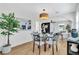 Bright dining area with modern light fixture, sleek black fireplace, and beautiful hardwood floors at 1234 29Th St N, St Petersburg, FL 33713