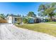 Charming single-story home featuring a gravel driveway and a light gray exterior at 1234 29Th St N, St Petersburg, FL 33713