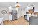 Modern kitchen with stainless steel refrigerator, hardwood floors, and white cabinets at 1234 29Th St N, St Petersburg, FL 33713