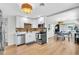 Modern kitchen with stainless steel appliances, white cabinets, hardwood floors, and eat in dining at 1234 29Th St N, St Petersburg, FL 33713