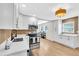 Modern kitchen with stainless steel appliances, white cabinets, quartz countertops and hardwood floors at 1234 29Th St N, St Petersburg, FL 33713