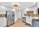Modern kitchen with stainless steel refrigerator, white cabinets, hardwood floors, and pantry at 1234 29Th St N, St Petersburg, FL 33713
