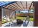 Backyard patio with a modern pergola, seating, and a cozy fire pit feature at 1234 29Th St N, St Petersburg, FL 33713