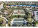 A bird's eye view of the tennis and bocce ball courts, playground, and neighborhood, offering various recreational activities at 12822 Del Corso Loop, Bradenton, FL 34211