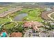 Stunning aerial view of the golf course, lake, and surrounding neighborhood at 12822 Del Corso Loop, Bradenton, FL 34211