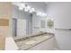 Bright bathroom with double vanity, granite countertop, mirrors, and tiled shower at 12822 Del Corso Loop, Bradenton, FL 34211