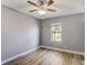 Bedroom with hardwood flooring, gray walls and a ceiling fan with lights at 12822 Del Corso Loop, Bradenton, FL 34211