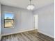 Well lit bedroom featuring hardwood floors, a window and an ensuite bathroom at 12822 Del Corso Loop, Bradenton, FL 34211