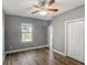 Bedroom with hardwood flooring, closet and a ceiling fan with lights at 12822 Del Corso Loop, Bradenton, FL 34211