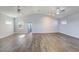 Spacious bonus room with vaulted ceilings, ceiling fans and grey toned plank flooring at 12822 Del Corso Loop, Bradenton, FL 34211