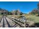 A wooden bridge over a tranquil creek with lush green surroundings at 12822 Del Corso Loop, Bradenton, FL 34211