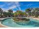Resort-style community pool featuring a tropical island oasis and ample lounge seating at 12822 Del Corso Loop, Bradenton, FL 34211