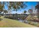 Scenic view of a wooden bridge crossing a waterway in a community with lush landscaping and blue skies at 12822 Del Corso Loop, Bradenton, FL 34211