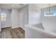Upstairs hallway with grey toned plank flooring and white trim with natural light at 12822 Del Corso Loop, Bradenton, FL 34211
