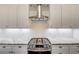 Close-up of a modern island kitchen featuring white cabinets, granite countertops, and a stainless steel range at 12822 Del Corso Loop, Bradenton, FL 34211