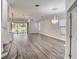 Bright, airy living room with hardwood floors, recessed lighting, fan, and access to the screened porch through sliding doors at 12822 Del Corso Loop, Bradenton, FL 34211