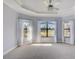 Spacious main bedroom featuring neutral tones, carpet, and three large windows for ample natural light at 12822 Del Corso Loop, Bradenton, FL 34211