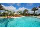 Beautifully landscaped community pool with comfortable lounge chairs and clear blue skies at 12822 Del Corso Loop, Bradenton, FL 34211
