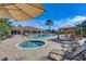 Beautiful pool and hot tub surrounded by lounge chairs, cabanas, and palm trees at 12822 Del Corso Loop, Bradenton, FL 34211