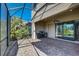 Covered outdoor patio with stone pavers, a ceiling fan, and outdoor kitchen with stainless grill at 12822 Del Corso Loop, Bradenton, FL 34211