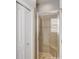 Tiled shower with a glass door and built-in bench, next to a closet at 12822 Del Corso Loop, Bradenton, FL 34211