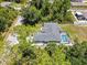 Overhead view of a home featuring a screened-in pool, landscaped backyard, and a private, wooded surroundings at 1298 Russellville St, North Port, FL 34288