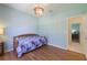 Bright bedroom with hardwood floors, a ceiling fan, and a large window with a lush view at 1298 Russellville St, North Port, FL 34288