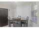 Cozy dining area with a wooden table set and view through a bright window at 1298 Russellville St, North Port, FL 34288