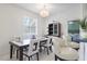 Charming dining room with a sleek table, chandelier, and views into a bedroom at 1298 Russellville St, North Port, FL 34288