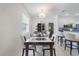 Elegant dining area featuring modern furnishings, a stylish chandelier, and plenty of natural light at 1298 Russellville St, North Port, FL 34288