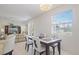 Bright dining room featuring modern table set, chandelier and view through a window at 1298 Russellville St, North Port, FL 34288
