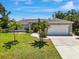 Well-maintained single-story home with a two-car garage, landscaped front yard, and inviting curb appeal at 1298 Russellville St, North Port, FL 34288