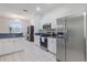 Well-lit kitchen featuring stainless steel appliances, white cabinets and chandelier lighting at 1298 Russellville St, North Port, FL 34288